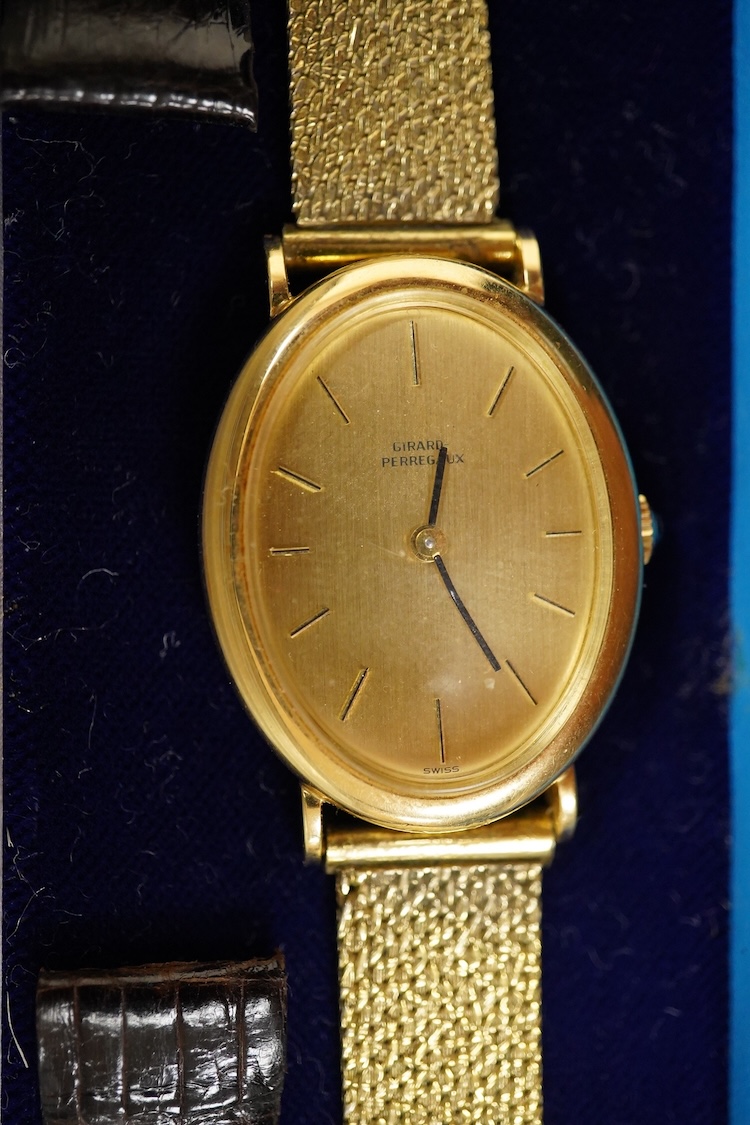 A gentleman's 18ct Girard-Perregaux manual wristwatch, oval brushed gilt dial with raised hour baton marks, seventeen jewels movement, signed, on an associated gilt metal articulated bracelet, in original case.